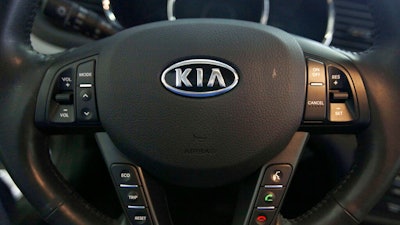 This Oct. 5, 2012, file photo, shows a Kia optima's steering wheel inside of a Kia car dealership in Elmhurst, Ill. Kia says it will ignore the partial U.S. government shutdown and recall more than 68,000 vehicles to fix a fuel pipe problem that can cause engine fires. The problem stems from previous recall repairs due to engine failures. Kia is only doing the fix on 68,000 of its 618,000 vehicles. The fuel injector pipe recall covers some 2011 through 2014 Optima cars, 2012 through 2014 Sorrento SUVs, and 2011 through 2013 Sportage SUVs, all with 2-liter and 2.4-liter four-cylinder engines.