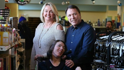 Doug Ketchum and his wife Mary pose with their daughter Stacie at their Memphis liquor store, Kimbrough Wine & Spirits.