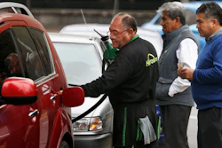 Commuters in Mexico City line up to fill their fuel tanks at a gas station, some of which are limiting how much each client can purchase.