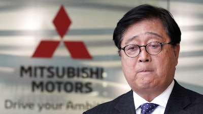 Mitsubishi Motors CEO Osamu Masuko bites his lips during a press conference at its headquarters in Tokyo Friday, Jan. 18, 2019. Masuko said the Japanese automaker's board met and discussed new allegations of wrongdoing by its former chairman, Carlos Ghosn.