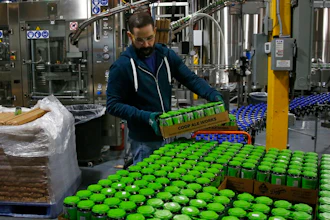 Josh Yager transfers cans of F5, one of their most popular brews, from the production line at COOP Ale Works in Oklahoma City, Friday, Jan. 18, 2019. Rules that went into effect in Oklahoma in October allow grocery, convenience and retail liquor stores to sell chilled beer with an alcohol content of up to 8.99 percent. Previously, grocery and convenience stores could offer only 3.2 percent beer. Liquor stores, where stronger beers were available, were prohibited from selling it cold.
