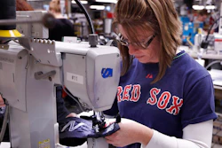 In this Monday, Dec. 17, 2018 photo, Nicole Sanborn stitches the upper section of a pair of athletic shoes designed for the military at a New Balance factory in Norridgewock, Maine. The first shipments of athletic shoes made for the U.S. Department of Defense are being shipped out. The new contract fulfills a federal law requiring the military to outfit new recruits with American-made apparel.