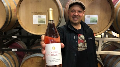 Joe Ibrahim, head winemaker at Willamette Valley Vineyards in Turner, Oregon, displays a bottle of rose of pinot noir made from grapes grown in southern Oregon that a California winemaker canceled a contract on purchasing just before harvest, claiming they were tainted by wildfire smoke.