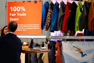 In this Wednesday, Jan. 30, 2019, photograph, a sign indicating items that were 100-percent fair trade-sewn marks a rack of jackets and shells in the Patagonia exhibit at the Outdoor Retailer & Snow Show in the Colorado Convention Center in Denver. Major players in the outdoor industry jumped into the political fight over national monuments two years ago and now have added climate change and sustainable manufacturing to their portfolio.