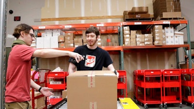 In this Nov. 16, 2018, file photo, Target employees sort boxed items from online orders to be shipped out to customers at at a Target store in Edison, N.J. For many retailers that have lifted pay to attract and keep workers, another challenge has arisen: Making those workers productive enough to justify the larger payouts.