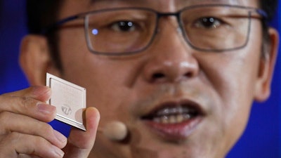Ryan Ding, chief of Huawei's carrier business group, holds a Tiangang 5G base station chipset, speaks during a product presentation in Beijing, Thursday, Jan. 24, 2019. Chinese tech giant Huawei announced plans to release a next-generation smartphone based on its own technology instead of U.S. components, stepping up efforts to compete with global industry leaders.