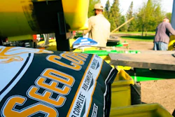 In this 2015 photo, a bag of corn seed sits ready for spring planting near Moorhead, Minn. Farmers Business Network compares seed prices from different companies to help farmers save money.