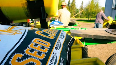 In this 2015 photo, a bag of corn seed sits ready for spring planting near Moorhead, Minn. Farmers Business Network compares seed prices from different companies to help farmers save money.