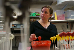 n this Friday, Jan. 11, 2019, photo Yael Krigman dips cakepops at her bakery Baked by Yael in Washington. The bakery is located across from Smithsonian's National Zoo that is closed because of the partial government shutdown.