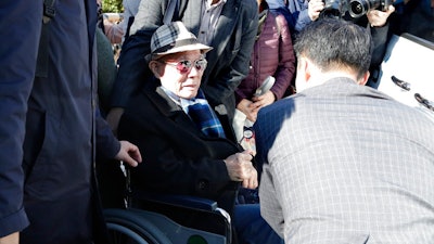 In this Oct. 30, 2018, file photo, South Korean Lee Chun-sik, 94-year-old victim of forced labor during Japan's colonial rule of the Korean Peninsula before the end of World War II, sits on a wheelchair upon his arrival at the Supreme Court in Seoul, South Korea. Lawyers for South Koreans forced into wartime labor have taken legal steps to seize the South Korean assets of a Japanese company they are trying to pressure into following a court ruling to provide them compensation.