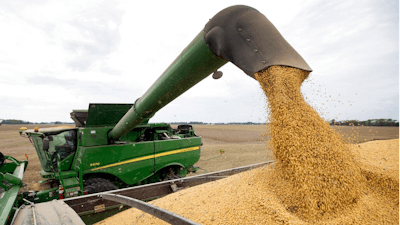 In this Sept. 21, 2018 file photo, Mike Starkey offloads soybeans from his combine as he harvests his crops in Brownsburg, Ind. The European Union has on Tuesday, Jan. 29, 2019 approved U.S. soybean exports to be used in the production of biofuels in an effort to boost such imports following last summer's trans-Atlantic meeting between President Donald Trump and his EU Commission counterpart Jean-Claude Juncker.
