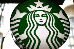 This Saturday, March 24, 2018, file photo, shows a sign at a Starbucks in the U.S. Starbucks is expanding its delivery service and aims to offer it at nearly one-fourth of its U.S. company-operated coffee shops.