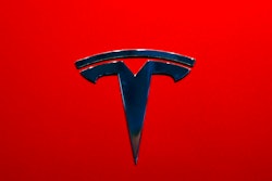 This Aug. 8, 2018, file photo shows a Tesla emblem on the back end of a Model S in the Tesla showroom in Santa Monica, Calif. The parents of a Florida teenager killed when a Telsa sedan crashed and caught fire last year are suing the electric car company alleging that the battery pack on its electric Model S is defective and can erupt into intense fires.