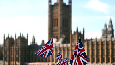 British Union flags fly in front of The Houses of Parliament in London.