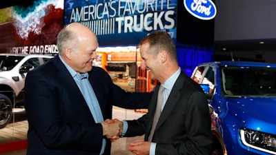 Ford Motor Co. President and CEO, Jim Hackett, left, meets with Dr. Herbert Diess, CEO of Volkswagen AG, Monday, Jan. 14, 2019, at the North American International Auto Show in Detroit.