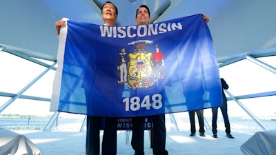In 2017, former Governor of Wisconsin, Scott Walker, stands with Terry Gou, chairman of Foxconn.