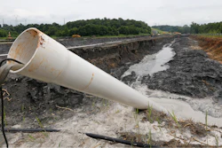 This June 26, 2015, file photo, shows a drain pipe that sticks out of a coal ash retention pond at the Dominion Power's Possum Point Power Station in Dumfries, Va. The Virginia General Assembly has reached a bipartisan agreement on a bill that would clean up large coal ash ponds across the state.