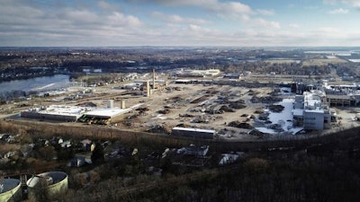 In this Nov. 21, 2018 photo, now eight months into demolition, the exterior facade of Janesville's former General Motors assembly plant remains, while much of the interior has been torn down, sorted into piles of like debris and trucked away from the grounds, in Janesville, Wis. Dec. 23, 2018, marks the 10-year anniversary of GM Janesville's main assembly lines shutting down.