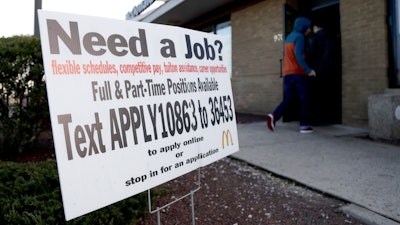 Customers enter a McDonald's restaurant near an employment sign in Atlantic Highlands, N.J.