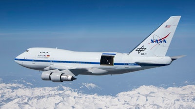 This undated photo provided by NASA shows SOFIA over the snow-covered Sierra Nevada mountains with its telescope door open during a test flight. The world's largest airborne observatory was supposed to be parked in Seattle this week, so thousands of scientists attending the 'Super Bowl of Astronomy' could behold this marvel: a Boeing 747, like this one shown, for example, outfitted with a massive telescope used to study the fundamental mysteries of the universe.