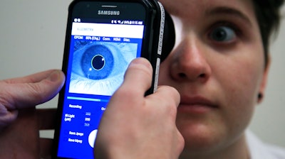 Clinical Research Assistant Kevin Jackson uses AlgometRx Platform Technology on Sarah Taylor's eyes to measure her degree of pain at the Children's National Medical Center in Washington, Monday, Dec. 10, 2018. Children's National Medical Center is testing an experimental device that aims to measure pain according to how pupils react to certain stimuli.