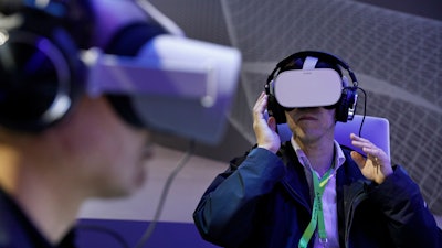 People use Oculus VR headsets at the Panasonic booth at CES International, Tuesday, Jan. 8, 2019, in Las Vegas.