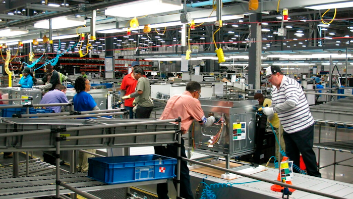In this Thursday, Jan. 9, 2014, file photo, workers assemble ovens at the new Electrolux home cooking appliance factory in Memphis, Tenn. Electrolux says it is stopping production at its Memphis, Tennessee, factory while investing $250 million in a separate facility in the state. The Stockholm-based maker of Frigidaire products said Thursday that it is consolidating all U.S. cooking manufacturing into its facility in Springfield.
