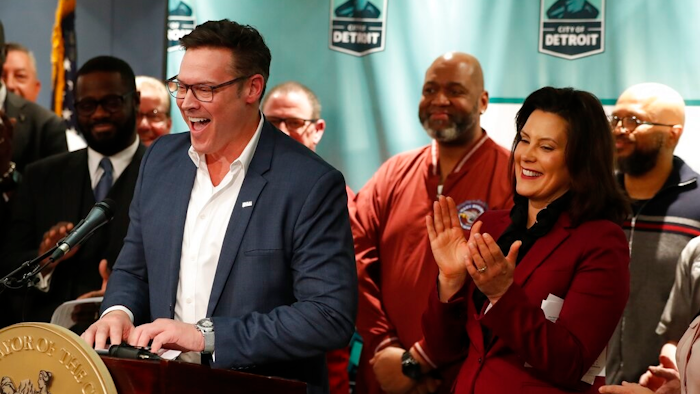 Fiat Chrysler Chief Operating Officer Mark Stewart stands with Gov. Gretchen Whitmer as he announces plans for Fiat Chrysler to build a new assembly plant include $12 million in tax abatements over a dozen years and 200 acres of land during a news conference in Detroit, Tuesday, Feb. 26, 2019. Mayor Mike Duggan's office said that the city will work with the state on other incentives for the automaker's $1.6 billion investment to convert its Mack Avenue Engine Complex into a new facility. The city has 60 days to get the land, 170 acres of which is owned by the city, a power utility, a public water authority and a family of prominent wealthy businessmen.