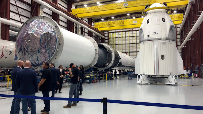 In this file photo, SpaceX's Dragon capsule, right, sits in a SpaceX hangar in Cape Canaveral, Florida.