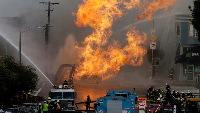 San Francisco firefighters battle a fire on Geary Boulevard in San Francisco. A gas explosion in a San Francisco neighborhood shot flames high into the air Wednesday and was burning several buildings as utility crews scrambled to shut off the flow of gas.
