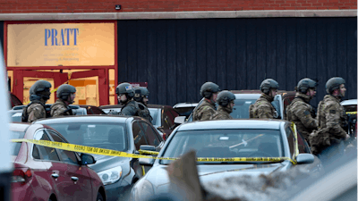 Law enforcement officers gather outside the Henry Pratt Co. manufacturing plant Friday, Feb. 15, 2019, in Aurora, Ill. Police say a gunman killed several people and injured police officers before he was fatally shot.