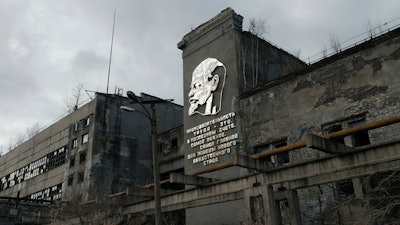 In this photo taken in 2018 and provided by Pavel Otdelnov, A view of an abandoned industrial building of the factory 'Zarya' in Dzerzhinsk, is on display at an exhibition in Moscow, Russia. Pavel Otdelnov, a Russian artist who grew up in Dzerzhinsk, the center of the nation's chemical industries 355 kilometers (220 miles) east of Moscow, focused on the city, one of the most polluted in Russia, in his new 'Promzona' art show.