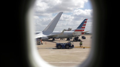 In this June 16, 2018, file photo, American Airlines aircrafts aircrafts are seen at O'Hare International Airport in Chicago. Newer seat-back entertainment systems on some airplanes operated by American Airlines and Singapore Airlines have cameras, and it’s likely they are also on planes used by other carriers. American and Singapore both said Friday, Feb. 22, 2019, that they have never activated the cameras and have no plans to use them.