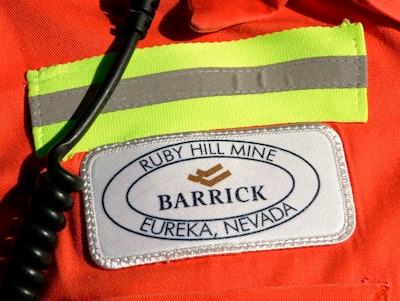 In this Feb. 14, 2006 file photo, a close-up of the chest patch of a worker at Barrick's Ruby Hill Mine, outside Eureka, Nev., is shown. Barrick Gold will try to acquire Newmont Mining Corp. in an all-stock deal that would create a mining behemoth worth about $42 billion. Newmont, based in Colorado, has shunned the Canadian miner so far, and the latest overture could become hostile. Barrick President and CEO Mark Bristow said that the two companies have highly complementary assets in Nevada, which includes Barrick’s mineral endowments and Newmont’s processing plants and infrastructure.