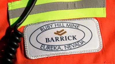 In this Feb. 14, 2006 file photo, a close-up of the chest patch of a worker at Barrick's Ruby Hill Mine, outside Eureka, Nev., is shown. Barrick Gold will try to acquire Newmont Mining Corp. in an all-stock deal that would create a mining behemoth worth about $42 billion. Newmont, based in Colorado, has shunned the Canadian miner so far, and the latest overture could become hostile. Barrick President and CEO Mark Bristow said that the two companies have highly complementary assets in Nevada, which includes Barrick’s mineral endowments and Newmont’s processing plants and infrastructure.