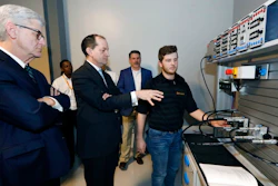 U.S. Secretary of Labor Alexander Acosta, center, asks about the hydraulic maintenance and troubling shooting simulator with a student, while Mississippi Gov. Phil Bryant, left, listens, at the Continental Tire manufacturing plant, Friday, Feb. 8, 2019, in Clinton, Miss., during a tour of the Continental Tire Training Center.