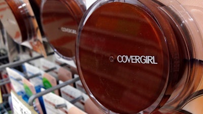 In this July 9, 2015, file photo a Covergirl makeup product hangs on a display at a store in Haverhill, Mass. German conglomerate JAB Holdings is seeking a majority stake in Coty Inc., which makes CoverGirl, Max Factor and Hugo Boss brand cosmetics and fragrances. JAB is offering to buy up existing stock from shareholders at $11.65 per share, marking a 20 percent premium from its closing on Monday, Feb. 11, 2019.