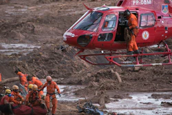 In this January 28, 2019 file photo, firefighters prepare a body to be lifted away by a helicopter in Brumadinho, Brazil.