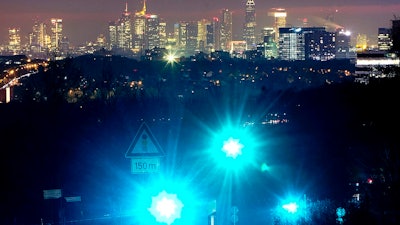 Green traffic lights shine above the city of Frankfurt, Germany, Tuesday, Feb. 5, 2019.