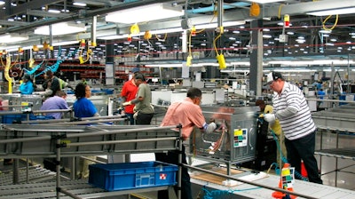 In this Thursday, Jan. 9, 2014, file photo, workers assemble ovens at the new Electrolux home cooking appliance factory in Memphis, Tenn. Electrolux says it is stopping production at its Memphis, Tennessee, factory while investing $250 million in a separate facility in the state. The Stockholm-based maker of Frigidaire products said Thursday that it is consolidating all U.S. cooking manufacturing into its facility in Springfield.