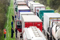In this April 6, 2016 file photo, truck drivers stand among trucks on the highway from Brussels to Luxembourg, in Spontin, Belgium. The European Union has reached a tentative agreement on the first specific EU standards for trucks to get polluting CO2 levels down. A Tuesday, Feb. 19, 2019, agreement between negotiators from the European Parliament and member states says that such emissions will have to be 30 percent down by 2030 compared to today's levels.