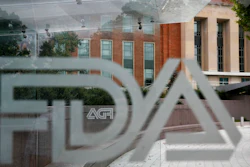 This Aug. 2, 2018 file photo shows the U.S. Food and Drug Administration building behind FDA logos at a bus stop on the agency's campus in Silver Spring, Md. The FDA announced plans Monday, Feb. 11, 2019, to step up its policing of dietary supplements, which it said has mushroomed into a $40 billion industry with more than 50,000 products.