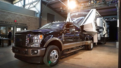 In a photo from, Wednesday, Jan. 30, 2019, in Detroit, a Ford F350 King Ranch truck is displayed at Eastern Market. All three Detroit automakers are rolling out new heavy-duty pickup trucks this year, courting buyers who tow heavy trailers for work or recreation. The introductions are sure to spark claims about horsepower, torque, towing capacity and payload hauling.