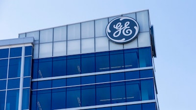 In this Jan. 16, 2018 file photo, the General Electric logo is displayed at the top of their Global Operations Center in the Banks development of downtown Cincinnati. General Electric says it will sell its biopharma business to Danaher Corp. for $21.4 billion as the former industrial giant continues to shrink itself. The biopharma unit was part of GE Life Sciences and had revenues of about $3 billion last year. The mostly-cash transaction is expected to close in the fourth quarter of this year.