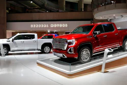 This Jan. 16, 2019, file photo shows a GMC Sierra pickup, left, and Denali in Detroit. General Motors' posted an $8.1 billion net profit last year as it got better prices for vehicles sold in the U.S., its most lucrative market. The performance was far better than the previous year, when the company lost $3.9 billion due to a giant tax accounting charge.