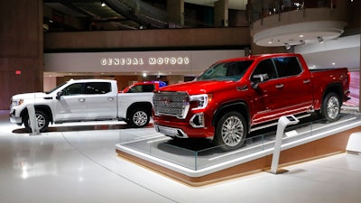 This Jan. 16, 2019, file photo shows a GMC Sierra pickup, left, and Denali in Detroit. General Motors' posted an $8.1 billion net profit last year as it got better prices for vehicles sold in the U.S., its most lucrative market. The performance was far better than the previous year, when the company lost $3.9 billion due to a giant tax accounting charge.