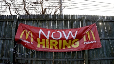 In this Jan. 3, 2019, file photo an employment sign hangs from a wooden fence on the property of a McDonald's restaurant in Atlantic Highlands, N.J. On Friday, Feb. 1, the U.S. government issues the January jobs report, which will reveal the latest unemployment rate and number of jobs U.S. employers added.