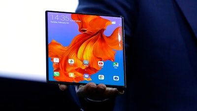 Huawei CEO Richard Yu displays the new Huawei Mate X foldable 5G smartphone at the Mobile World Congress, in Barcelona, Spain, Sunday, Feb. 24, 2019. The fair started with press conferences on Sunday, before the doors open on Monday, Feb. 25, and runs until Feb. 28.