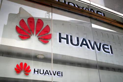 In this Jan. 29, 2019, file photo, the logos of Huawei are displayed at its retail shop window reflecting the Ministry of Foreign Affairs office in Beijing. The head of Britain's cybersecurity agency says government oversight of Huawei has proven it can flag up security problems, suggesting he doesn't think the Chinese company needs to be banned from supplying mobile networks. Ciaran Martin, the CEO of the National Cyber Security Centre, also said Wednesday, Feb. 20, 2019 that one of the conditions for maintaining good cybersecurity is having 'sustainable diversity' in the telecommunications equipment supplier market.