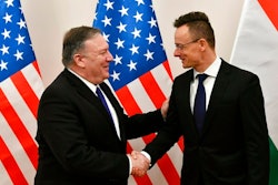 Hungarian Minister of Foreign Affairs and Trade Peter Szijjarto, right, shakes hands with US Secretary of State Mike Pompeo in the ministry in Budapest, Hungary, Monday, February 11, 2019. Pompeo is on an official visit to Hungary.